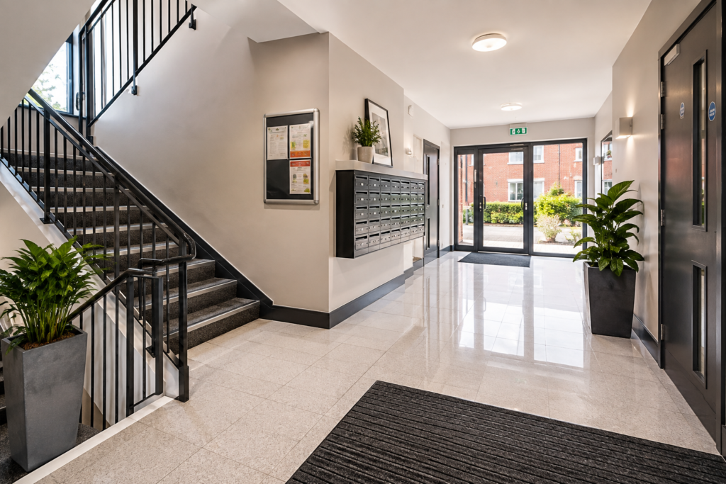 Clean and well-maintained communal entrance and stairway in a modern residential building.